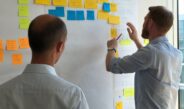 man in gray shirt facing sticky notes