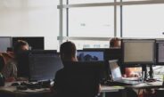 people sitting on chair in front of computer monitor